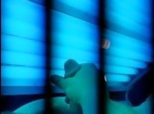 Watch me tense up as i cum on myself in this tanning bed
