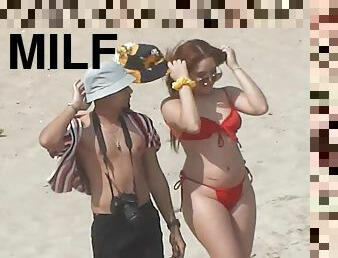 Redhead MILF with perfect body comes to beach