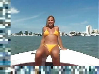 Blonde in yellow bikini models her pussy on a boat