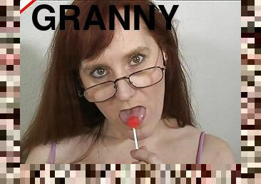 Slutty granny licks a lollipop and sucks on a thick rod