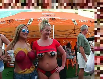 Body painted beauties playing at a street fair