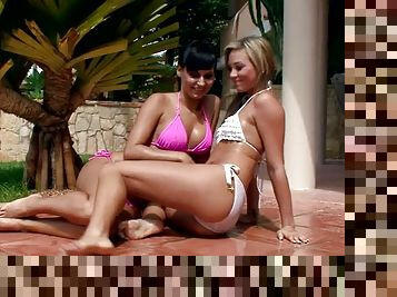Two cute girls play with a water hose and make lesbian love outdoors