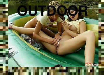 Two sexy chicks float in a raft, strip and fuck on the river