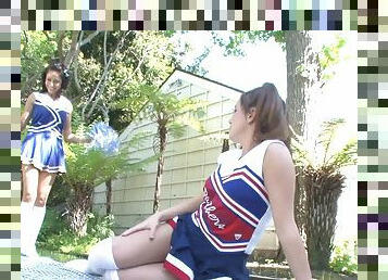 Stunning coed lesbians in cheerleader uniforms having sex outdoors