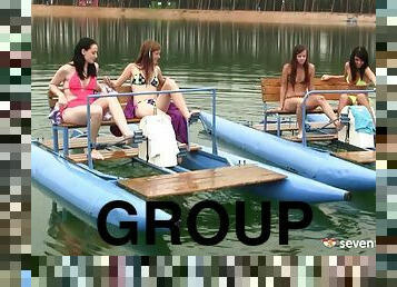 A group of hot, naked lesbians have an orgy on a lake