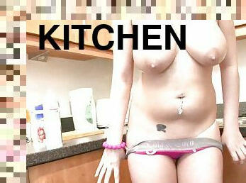 Watch this little redhead tease you with her body in the kitchen