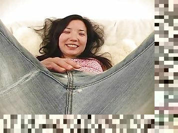 This Asian girl sheds her jeans and fucks her pussy with a toy