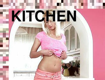 Tantalizing blonde masturbating erotically in kitchen