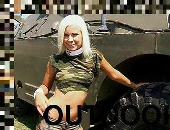 A hot military girl climbs off an armored vehicle and gets herself off