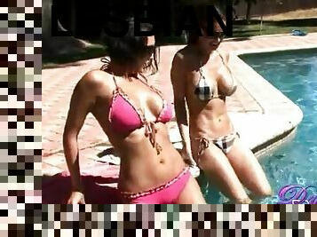 Adorable lesbians in sexy bikinis do it erotically at the pool outdoors in a reality shoot