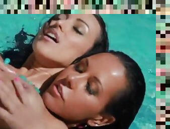 Radiant lesbian brunettes enjoying a candid pussy toying session in the pool