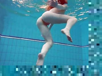 Swimming redhead strips underwater to tease us