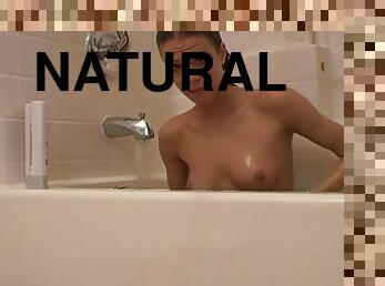 Cute teen pleasuring her tight pussy in the bath tub