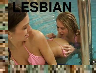 Enchanting lesbian teens experiment with a dildo in the pool