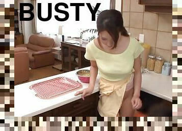 Topless and busty Japanese girl blows two guys in her kitchen