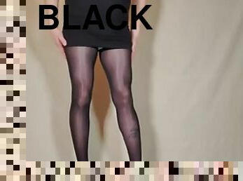 She teases in her black pantyhose, miniskirt and high heels