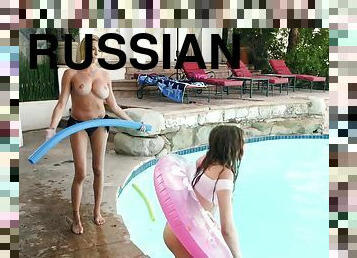Pretty Russian babe pleasuring busty MILF by the pool