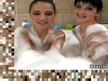 Two slim brunettes get all their holes smashed in a jacuzzi