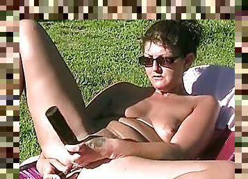 Brown-haired milf stuffs her cunt and ass with toys in the garden