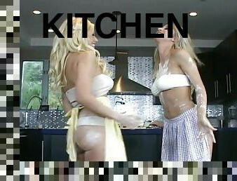Two blonde bombshells enjoy licking each other's pussies in the kitchen
