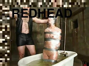 Redhead hussy Ivy gets drowned and humiliated in a hot BDSM clip