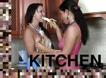 Hot girls toy each other with a banana and dildo