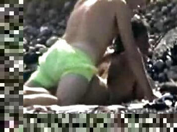 Woman gets her snatch pounded from behind on a beach