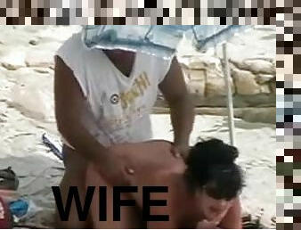 Lewd dude fucks his chubby wife doggy style on a beach