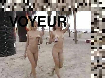 Voyeur cam catches two pretty slim girls on a nude beach