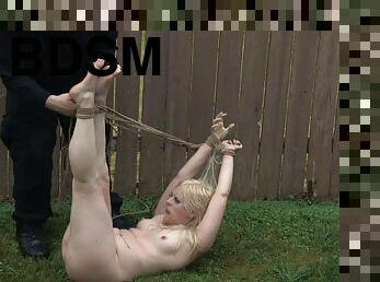 Pretty girl flogged and fondled as she sits in rope bondage