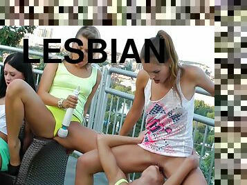 A big lesbian orgy with the horny chicks on a balcony with a view