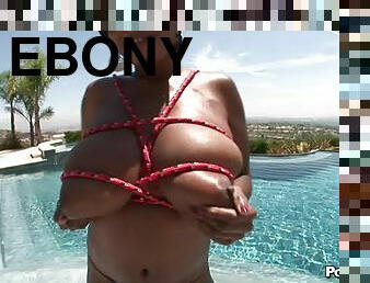 Charming ebony fondling her big natural tits at the pool