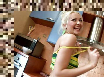 Sexy Angy kneels down on the kitchen floor and gets poked with a toy