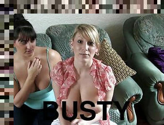 Two busty moms are sitting on the sofa
