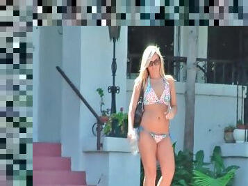 Girl walks out of her house and to her car in bikini