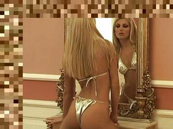 Blonde bombshell poses for the cam in her golden bikini