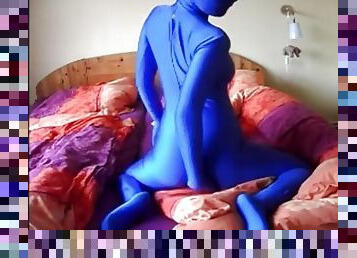 Beautiful woman masturbates in blue zentai