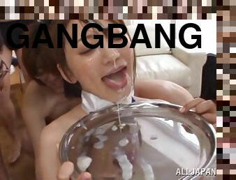 Saki Kouzai enjoys a bukkake and eats the cum in gangbang scene