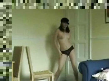 Girl in a baseball cap dancing topless