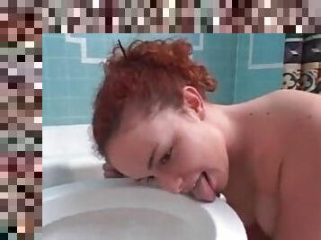 Redhead licks toilet and lets him piss on her