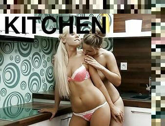 Two cute girls enjoy licking each other's pussies in the kitchen