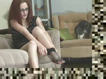 Sexy redhead chick puts her stocking on in softcore reality clip