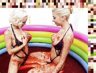 Hot blonde lesbians playing around in a pool full of syrup