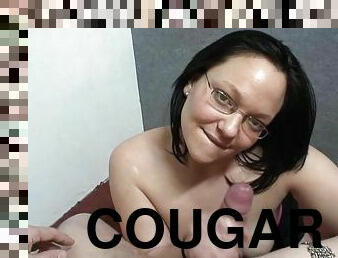 Chubby cougar with glasses playing with a stranger's cock