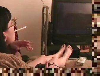 Mina plays a videogame and smokes