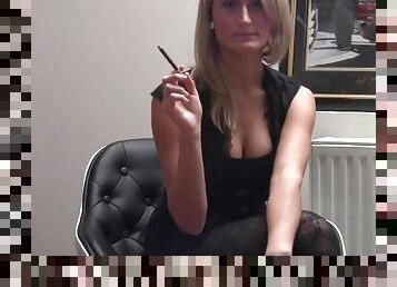 Girl in tights and a sexy top smokes a cigarette