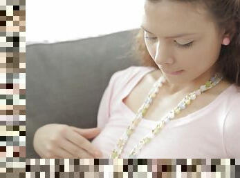 Girl with a pear necklace fingers herself on the floor