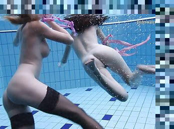Two sexy babes show off their hot naked bodies under the water