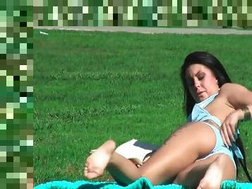 She tans in the park and he fondles her ass