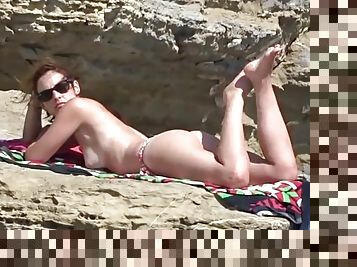 Sexy topless redhead spied on at the beach